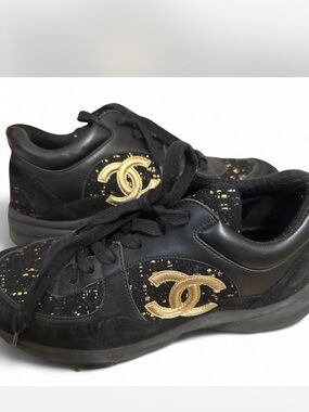 CHANEL Black and Gold Signature Logo Slip-On Sneakers
